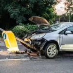 A damaged car that crashed into a lamp post on a London street during twilight
