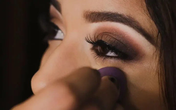 Close-up photo capturing the detailed application of eye makeup on a woman's face